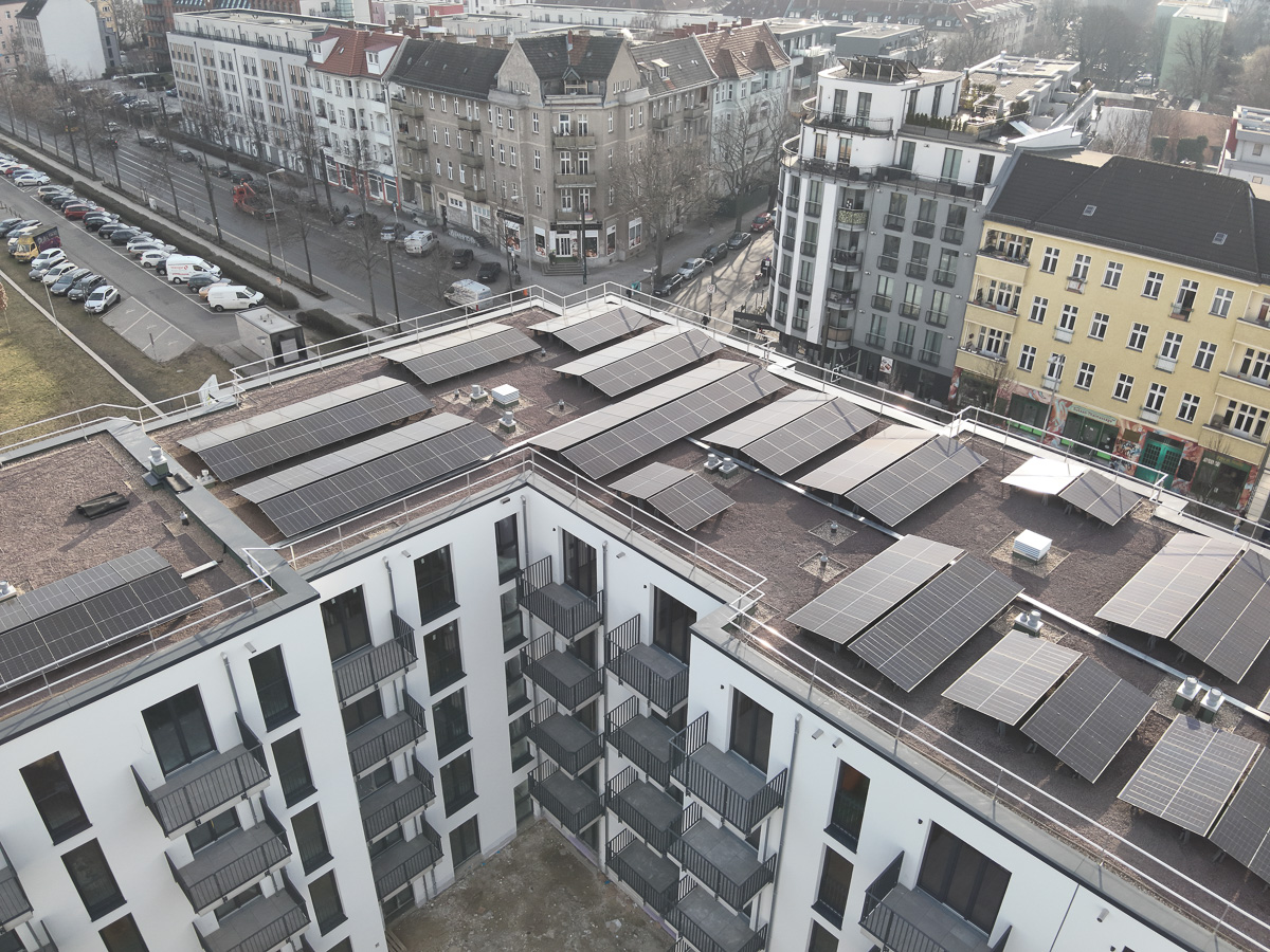 Neubau-Wohnquartiers mit installierter Photovoltaikanlage auf den Flachdächern der Mehrfamilienhäuser. Das Projekt zeigt die professionelle Umsetzung einer großflächigen PV-Anlage zur nachhaltigen Stromerzeugung im urbanen Wohnungsbau. Die Solarmodule wurden auf mehreren Gebäuden montiert und tragen zur CO₂-Reduzierung sowie zur Energieeffizienz moderner Wohnanlagen bei.